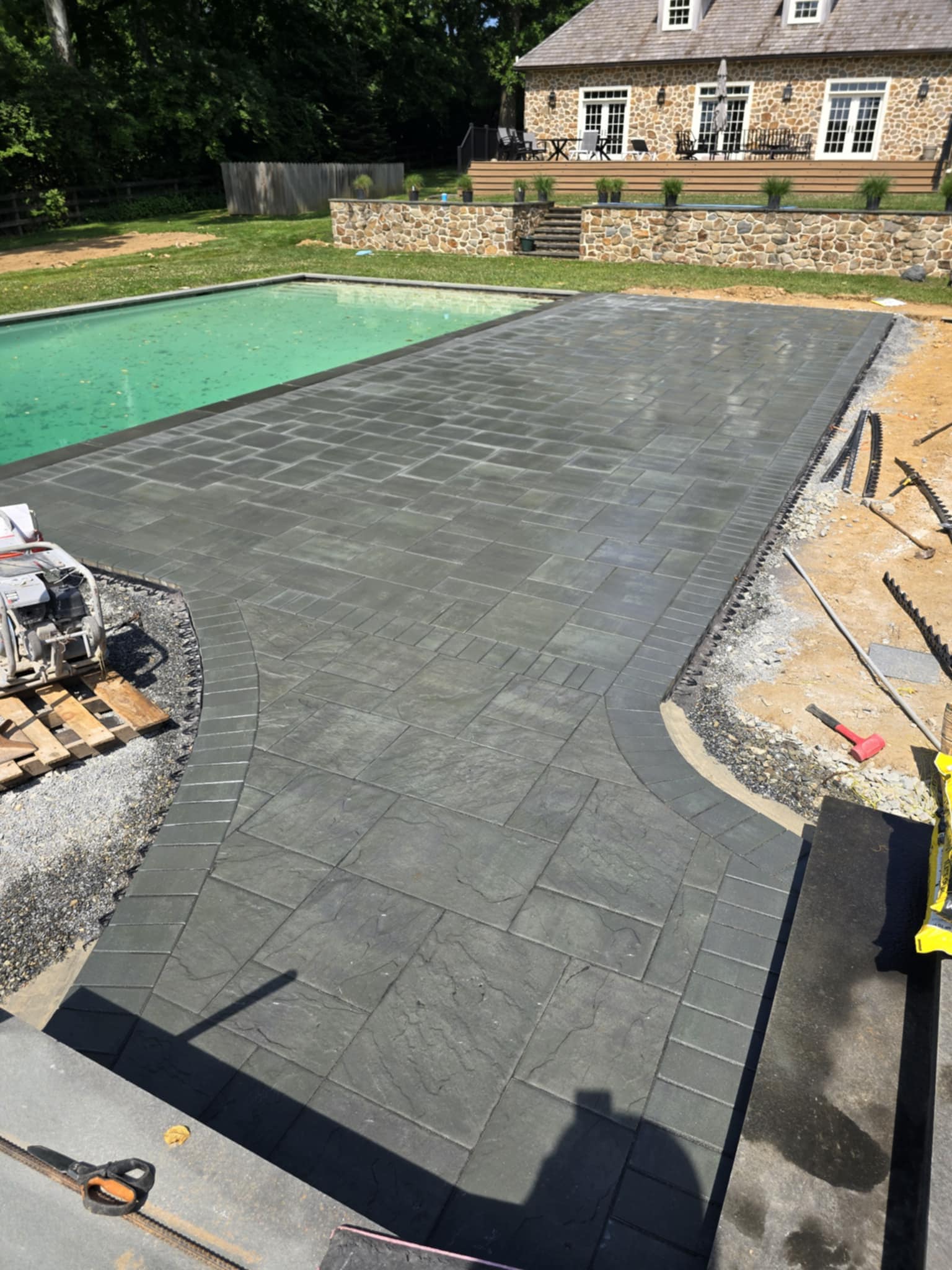 Paver patio near a pool in Chadds Ford